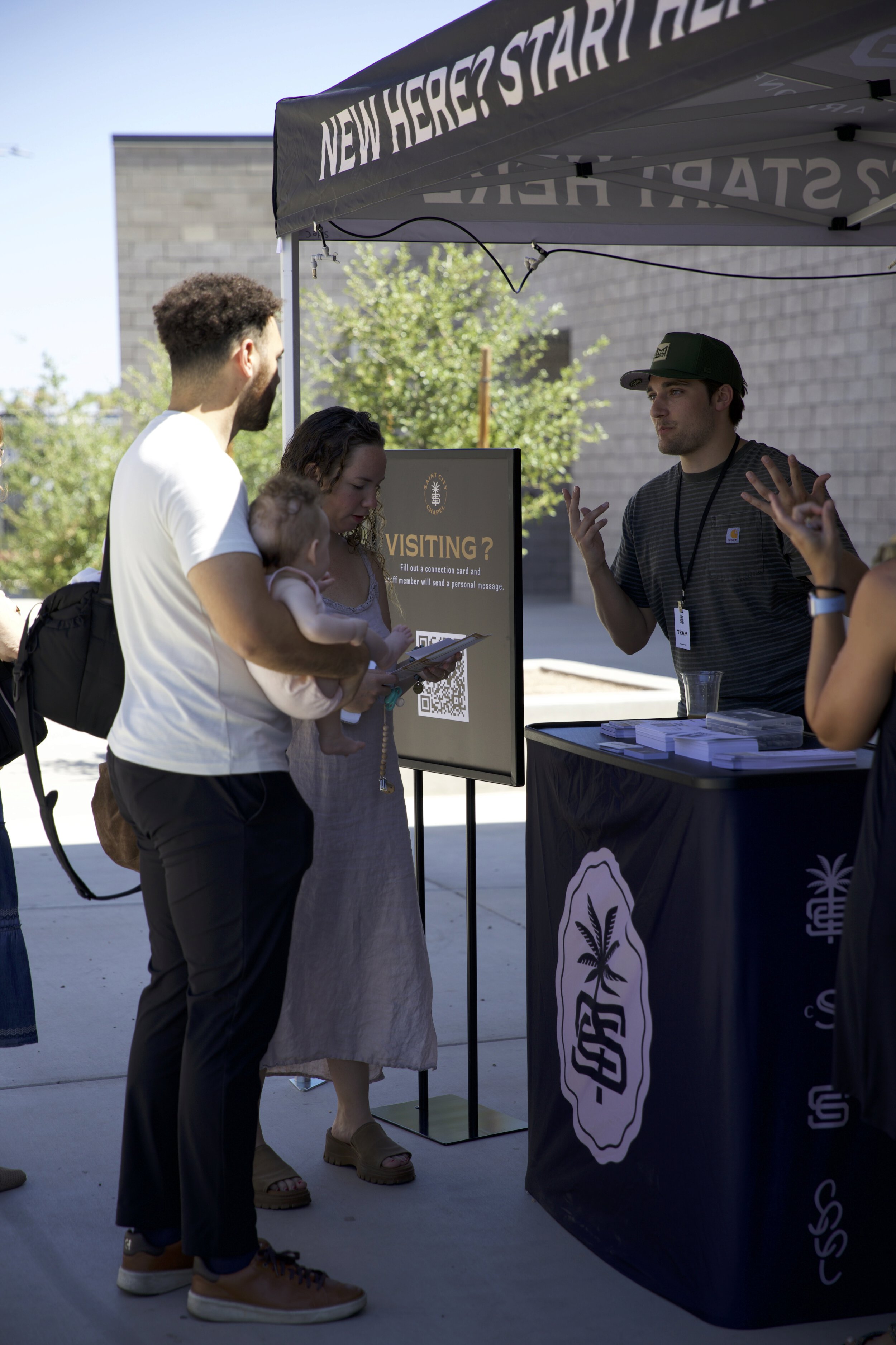 Saint City Chapel staff and guests at the information desk, welcoming new visitors